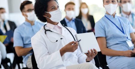 African American female doctor attending healthcare seminar with